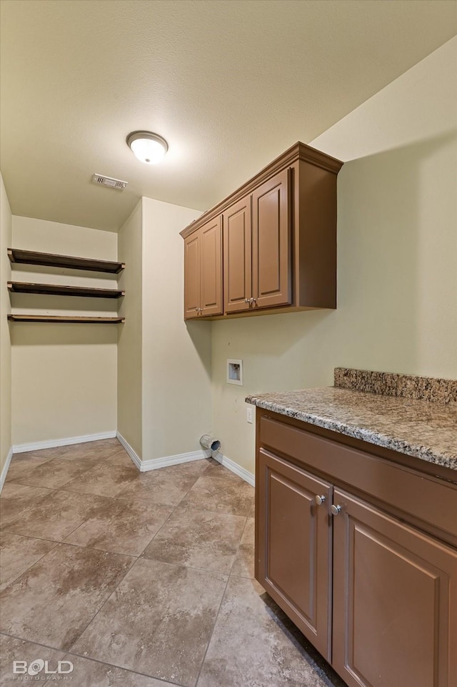 washroom with cabinets and washer hookup