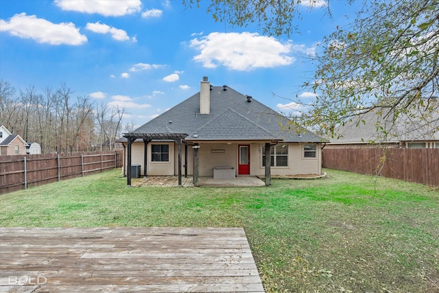 back of property with a pergola, a wooden deck, a lawn, and a patio