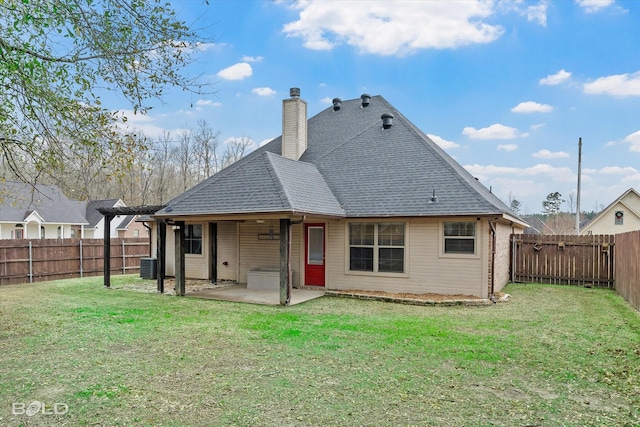 rear view of house with central AC, a yard, and a patio