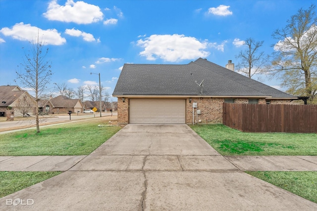 view of front of house with a garage and a front lawn