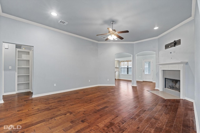 unfurnished living room featuring dark hardwood / wood-style floors, ceiling fan, and crown molding