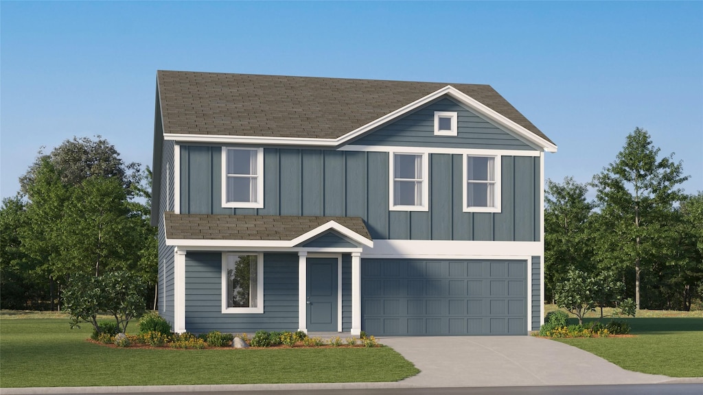 view of front of property with a garage and a front lawn