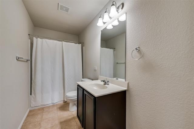 bathroom featuring tile patterned floors, vanity, and toilet