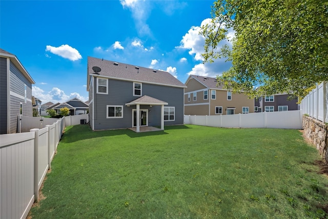 rear view of property with a patio area and a yard