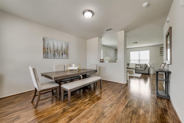 dining space featuring dark wood-type flooring