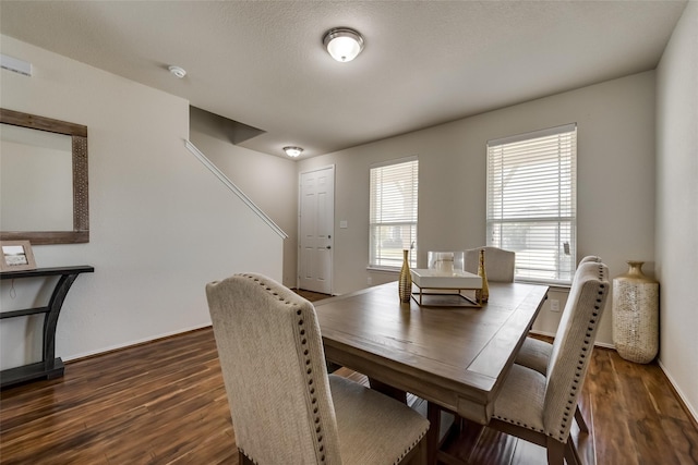 dining space featuring dark hardwood / wood-style floors and a wealth of natural light