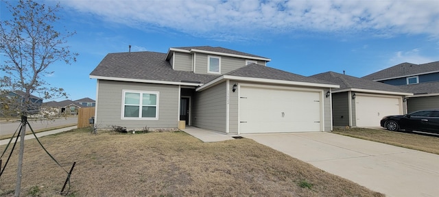 view of front of property with a garage and a front lawn