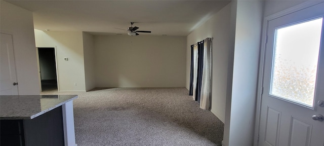 hallway featuring light colored carpet