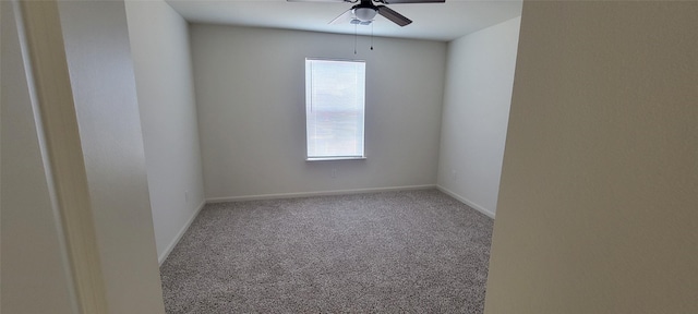 empty room with ceiling fan and carpet