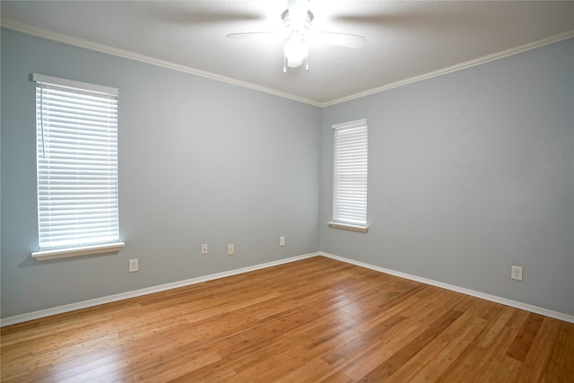 empty room with crown molding, wood-type flooring, and ceiling fan