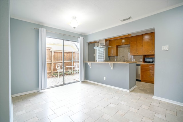 kitchen with wall chimney range hood, a breakfast bar, backsplash, stainless steel dishwasher, and kitchen peninsula