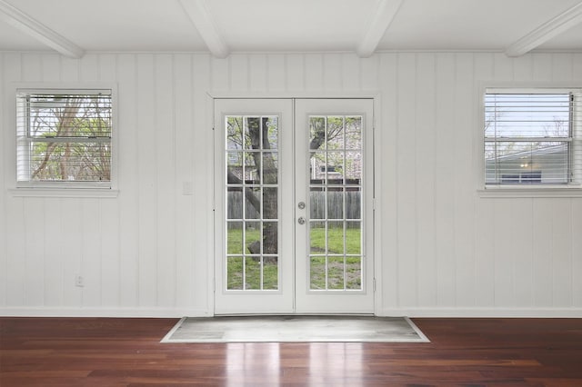 doorway to outside with beam ceiling, dark hardwood / wood-style flooring, and french doors