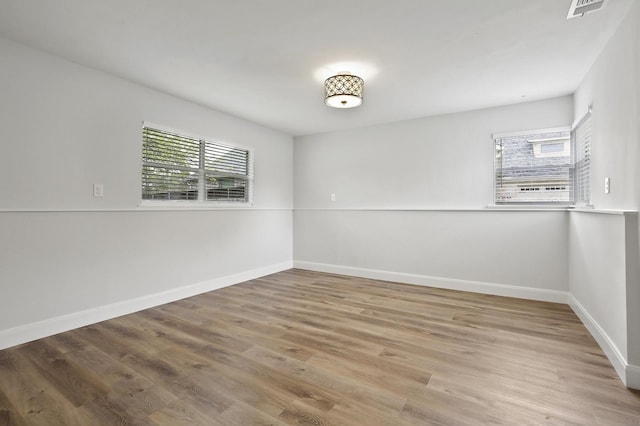 unfurnished room featuring hardwood / wood-style flooring