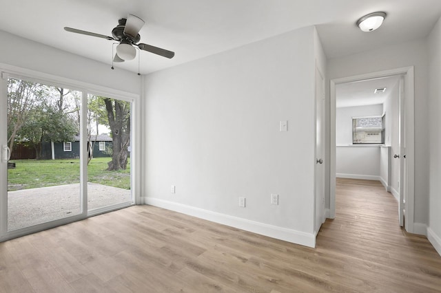 unfurnished room with light wood-type flooring and ceiling fan