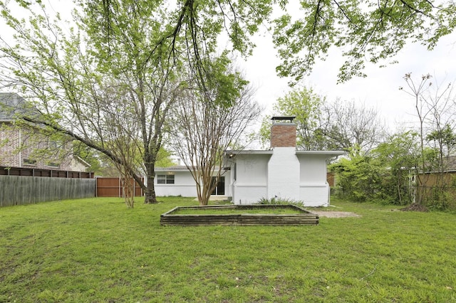 rear view of property with a yard