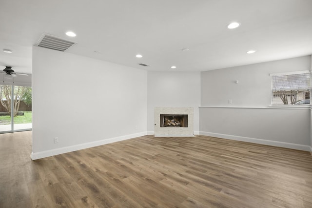 unfurnished living room featuring hardwood / wood-style floors and ceiling fan