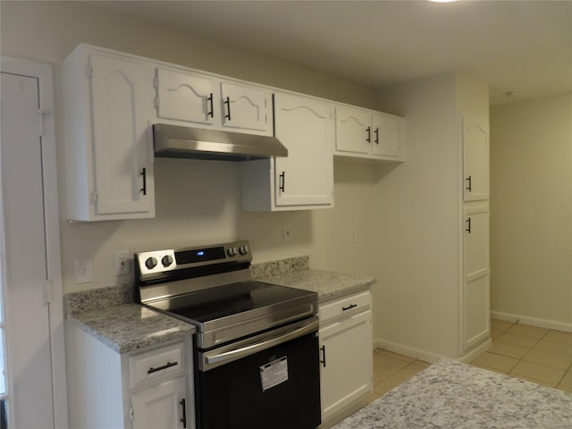 kitchen featuring light tile patterned flooring, white cabinetry, and stainless steel electric range