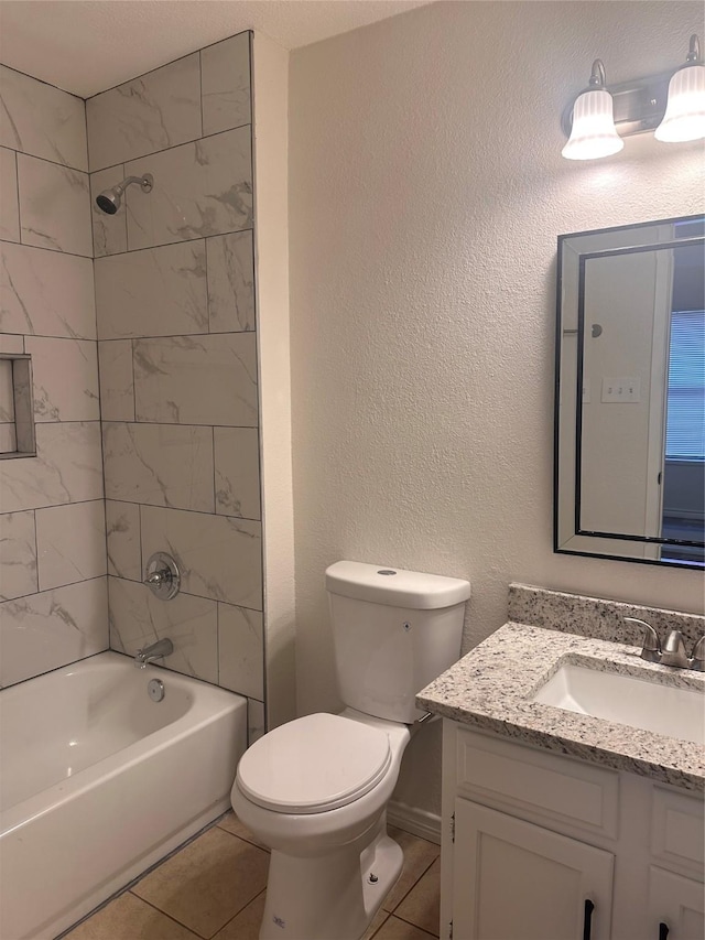 full bathroom with tile patterned floors, vanity, toilet, and tiled shower / bath