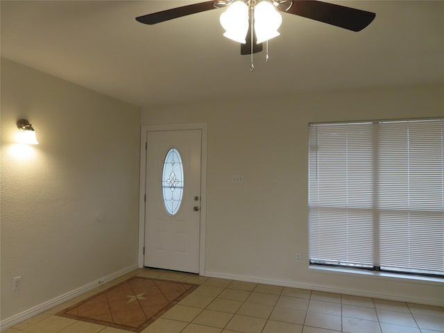 entryway with ceiling fan and light tile patterned flooring