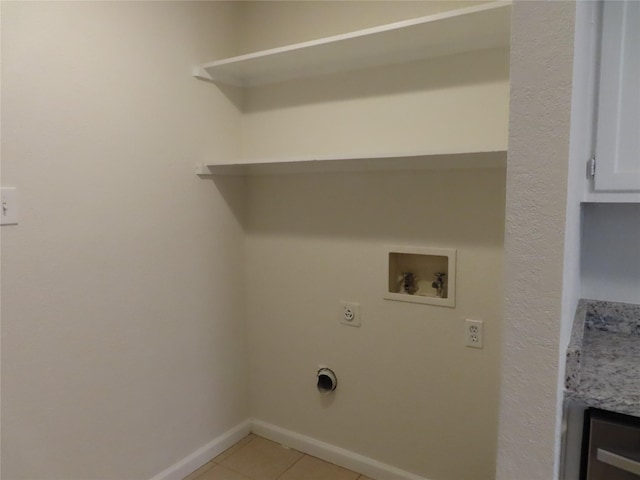 laundry room with hookup for an electric dryer, washer hookup, and light tile patterned floors