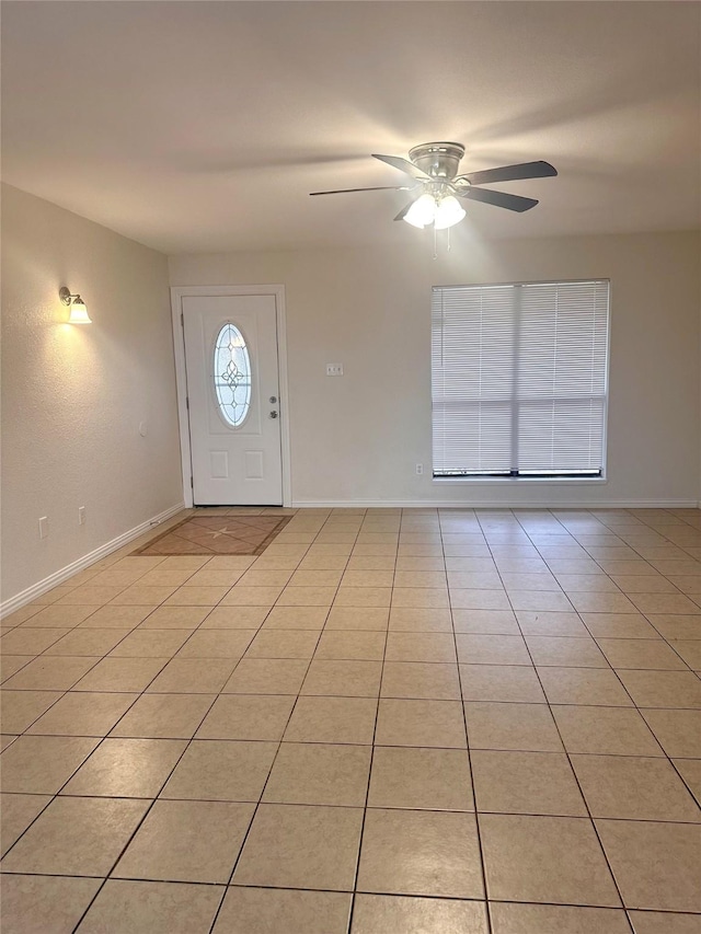 entrance foyer with light tile patterned floors and ceiling fan