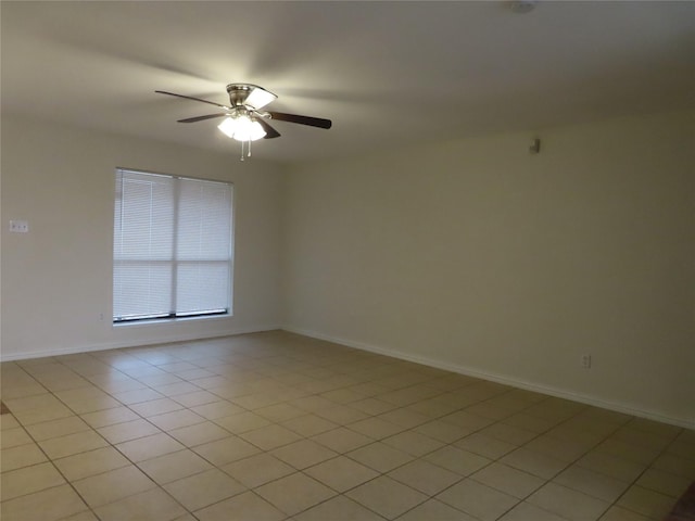 spare room featuring ceiling fan and light tile patterned flooring