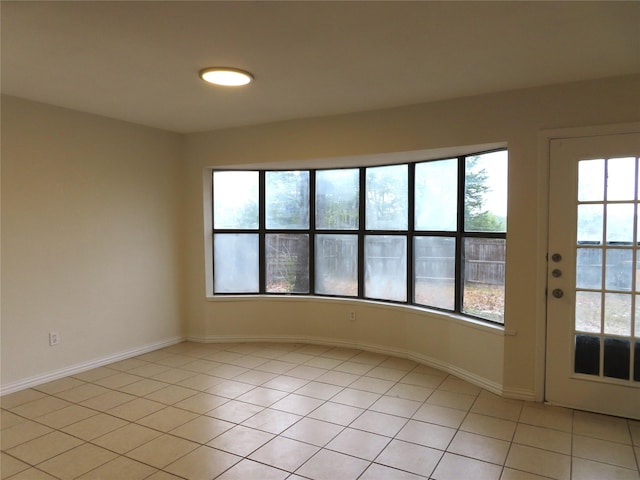 tiled spare room with plenty of natural light