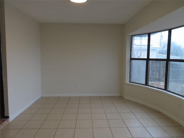 unfurnished room featuring light tile patterned flooring