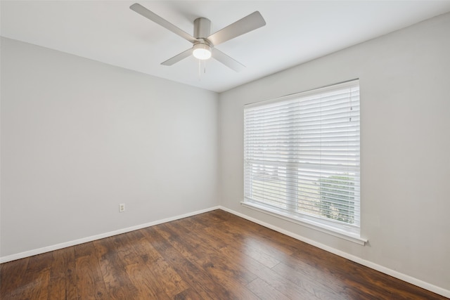 empty room with dark wood-type flooring and ceiling fan