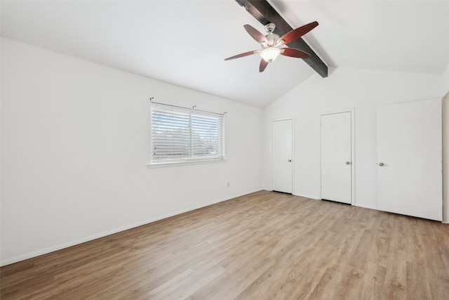 unfurnished bedroom featuring multiple closets, ceiling fan, lofted ceiling with beams, and light wood-type flooring