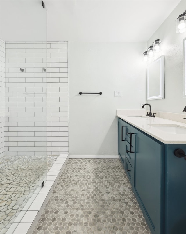 bathroom with vanity and a tile shower