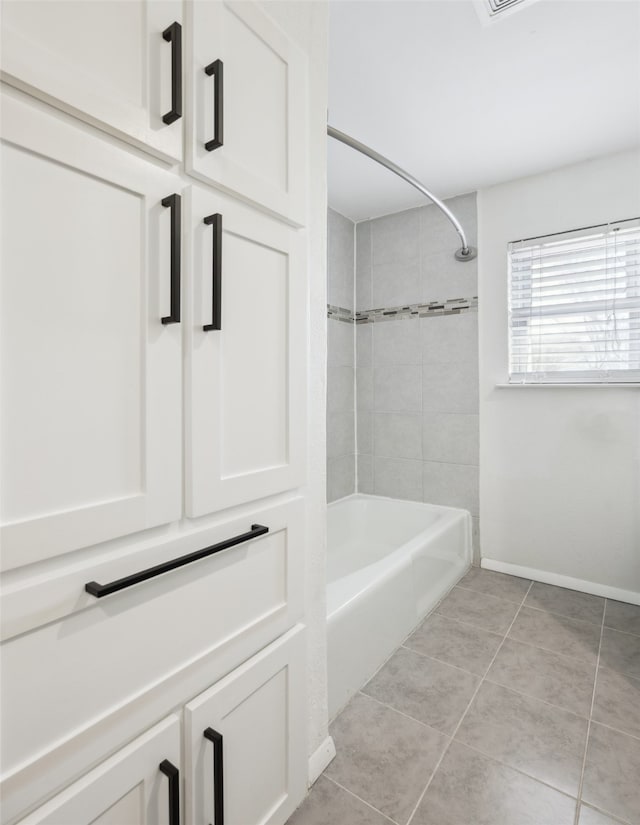 bathroom featuring tile patterned flooring and tiled shower / bath