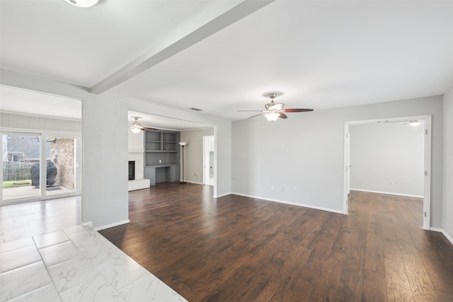 unfurnished living room featuring dark hardwood / wood-style floors, beam ceiling, ceiling fan, and a brick fireplace