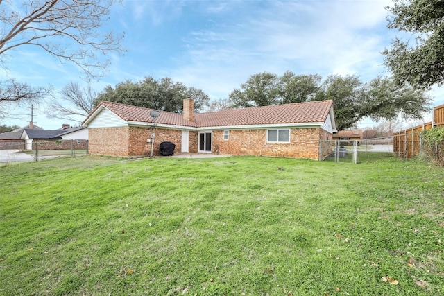 rear view of house featuring a patio and a lawn