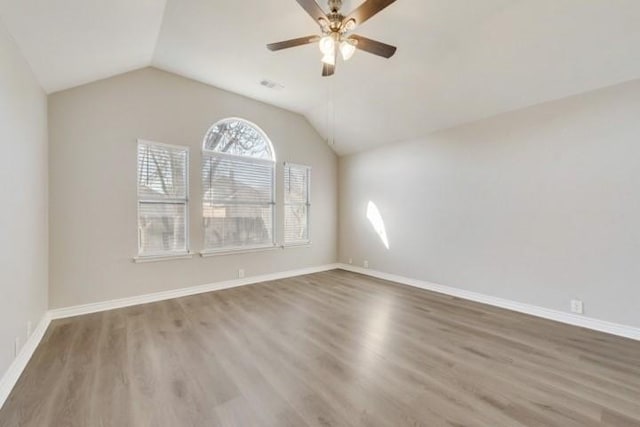 empty room with hardwood / wood-style floors, ceiling fan, and lofted ceiling