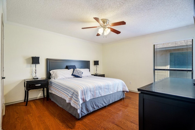 bedroom featuring ornamental molding, a textured ceiling, and dark hardwood / wood-style flooring