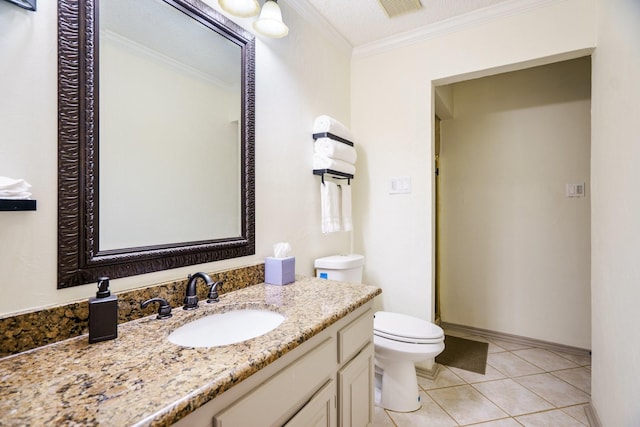 bathroom with tile patterned flooring, ornamental molding, vanity, and toilet