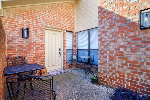 view of exterior entry featuring a patio