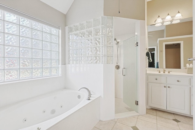 bathroom with tile patterned flooring, shower with separate bathtub, vanity, and lofted ceiling