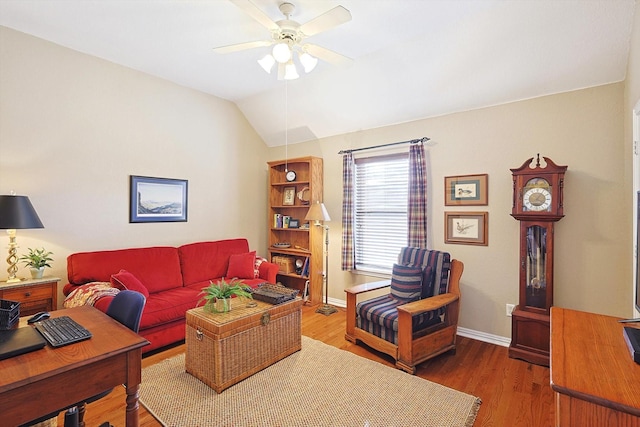 living room with hardwood / wood-style flooring, vaulted ceiling, and ceiling fan