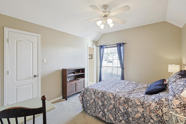 bedroom featuring light colored carpet, vaulted ceiling, and ceiling fan