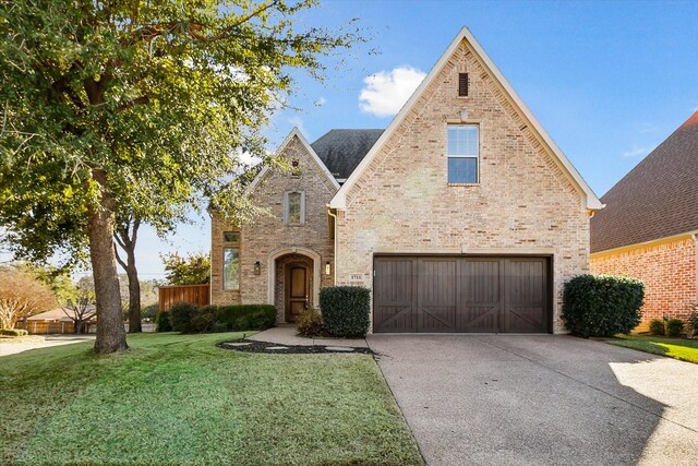 view of front of house with a garage and a front lawn