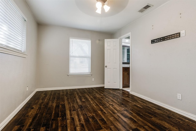 empty room featuring ceiling fan and dark hardwood / wood-style flooring