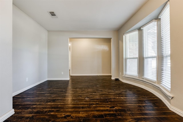 spare room with dark hardwood / wood-style floors