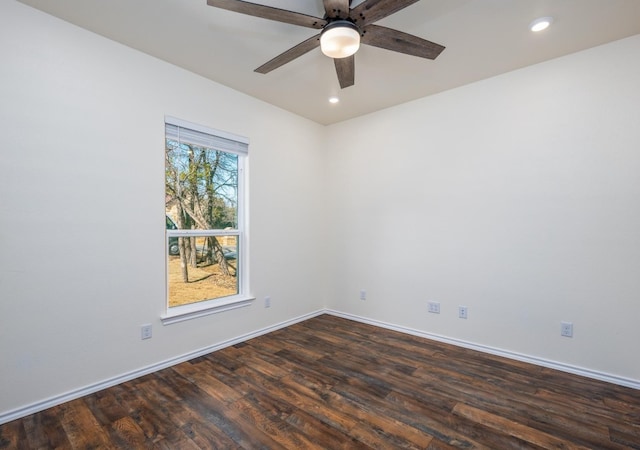 spare room with dark hardwood / wood-style floors and ceiling fan