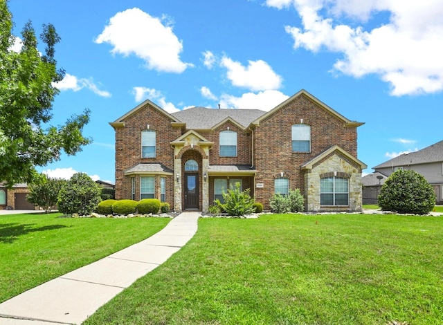 traditional home with brick siding and a front yard