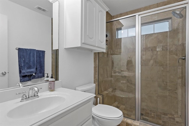 bathroom featuring vanity, toilet, and walk in shower