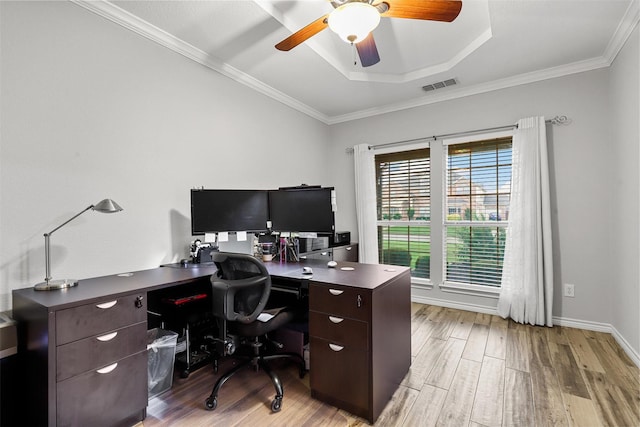 home office featuring ceiling fan, visible vents, crown molding, wood finished floors, and a raised ceiling