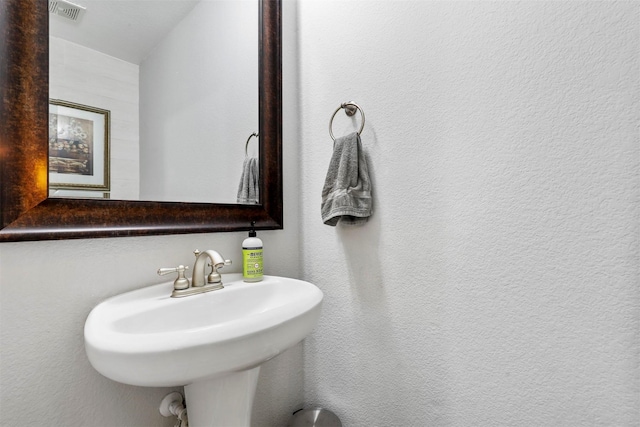 bathroom featuring visible vents and a sink