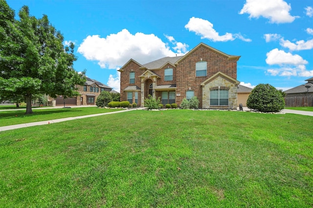 traditional-style home featuring brick siding, fence, and a front lawn